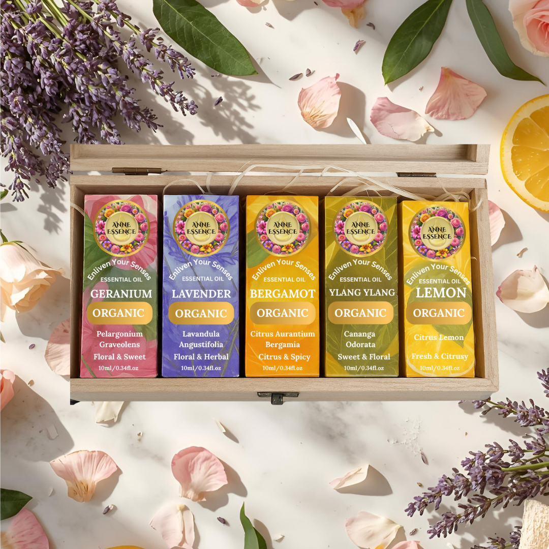 Anne Essence Luxury Organic Essential Oil Gift Box with 5 oils (Geranium, Lavender, Bergamot, Ylang Ylang, Lemon) presented in a wooden box with flowers and petals.