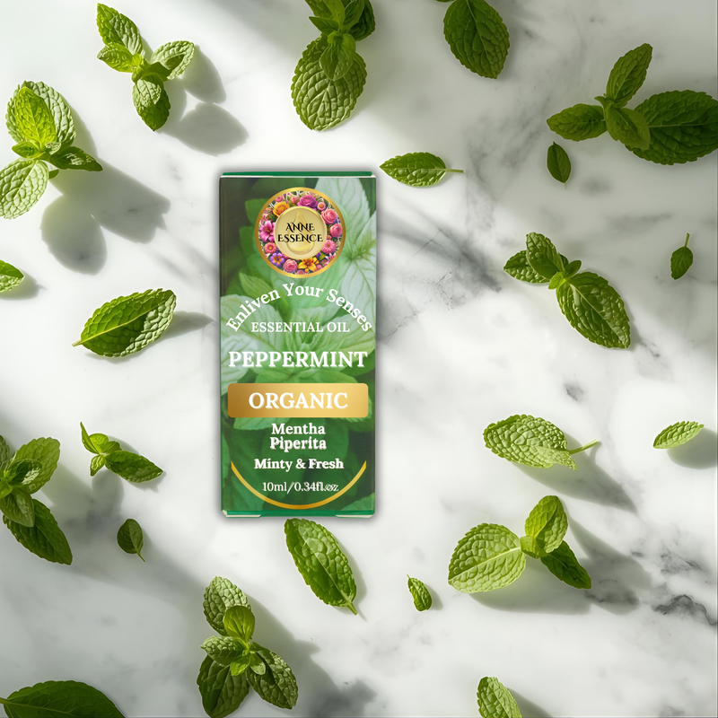 Anne Essence Organic Peppermint Essential Oil packaging displayed on a marble surface with fresh mint leaves, symbolizing freshness and purity.